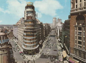 La Gran Vía à Madrid avec le bâtiment Carrión (Capitole) et l’enseigne publicitaire de cigarette Camel au sommet, un exemple d’identité graphique urbaine.